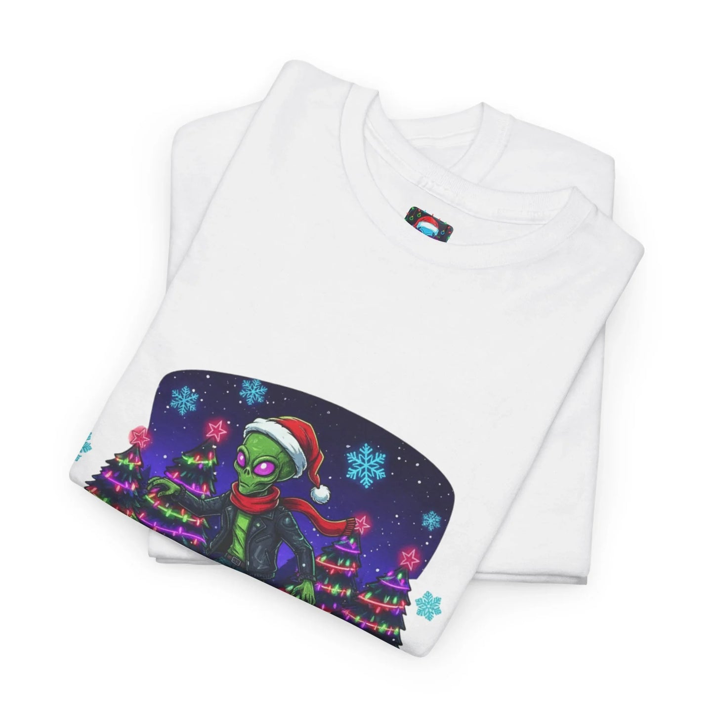White t-shirt with Christmas alien graphic, Santa hat, holiday trees, and snowflakes