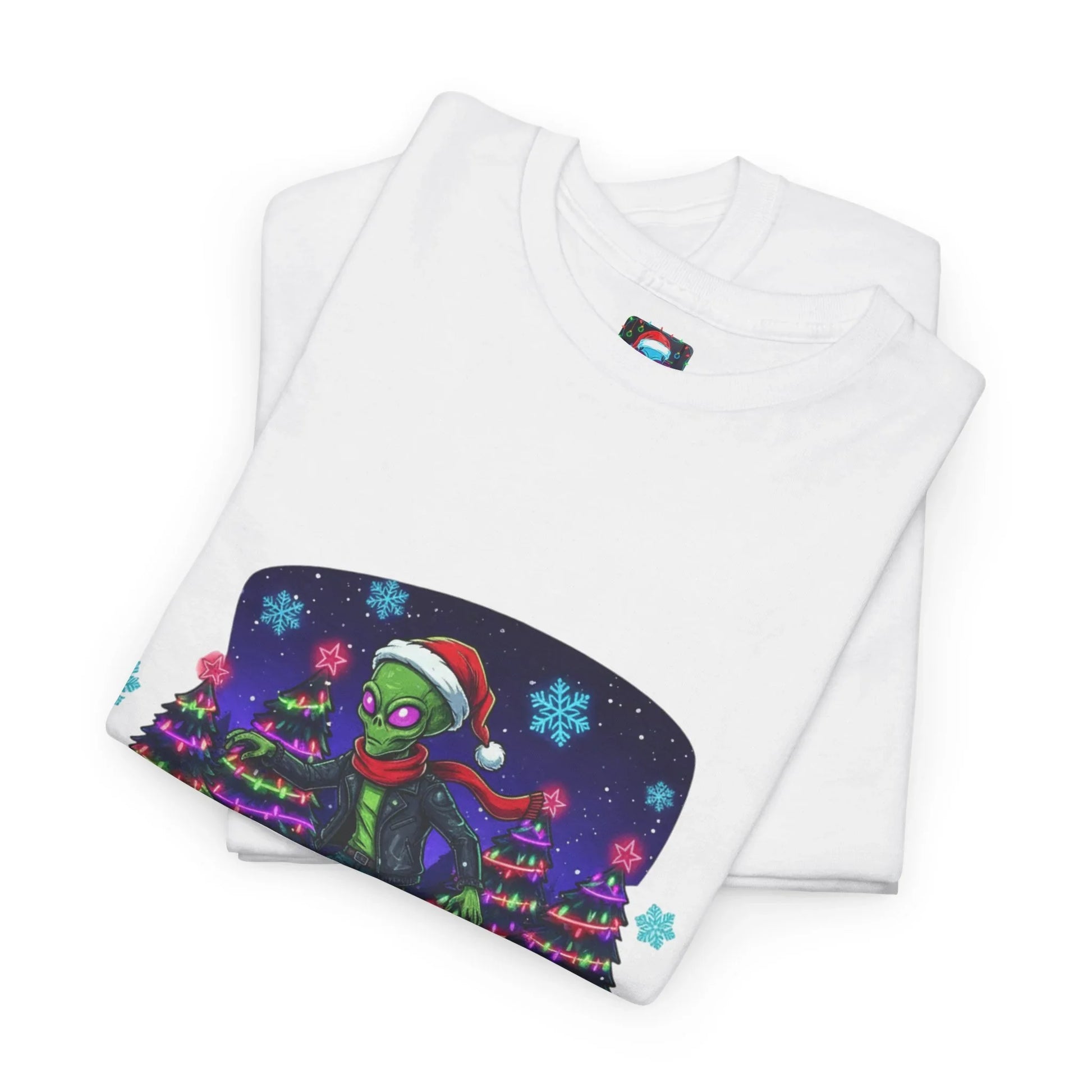 White t-shirt with Christmas alien graphic, Santa hat, holiday trees, and snowflakes