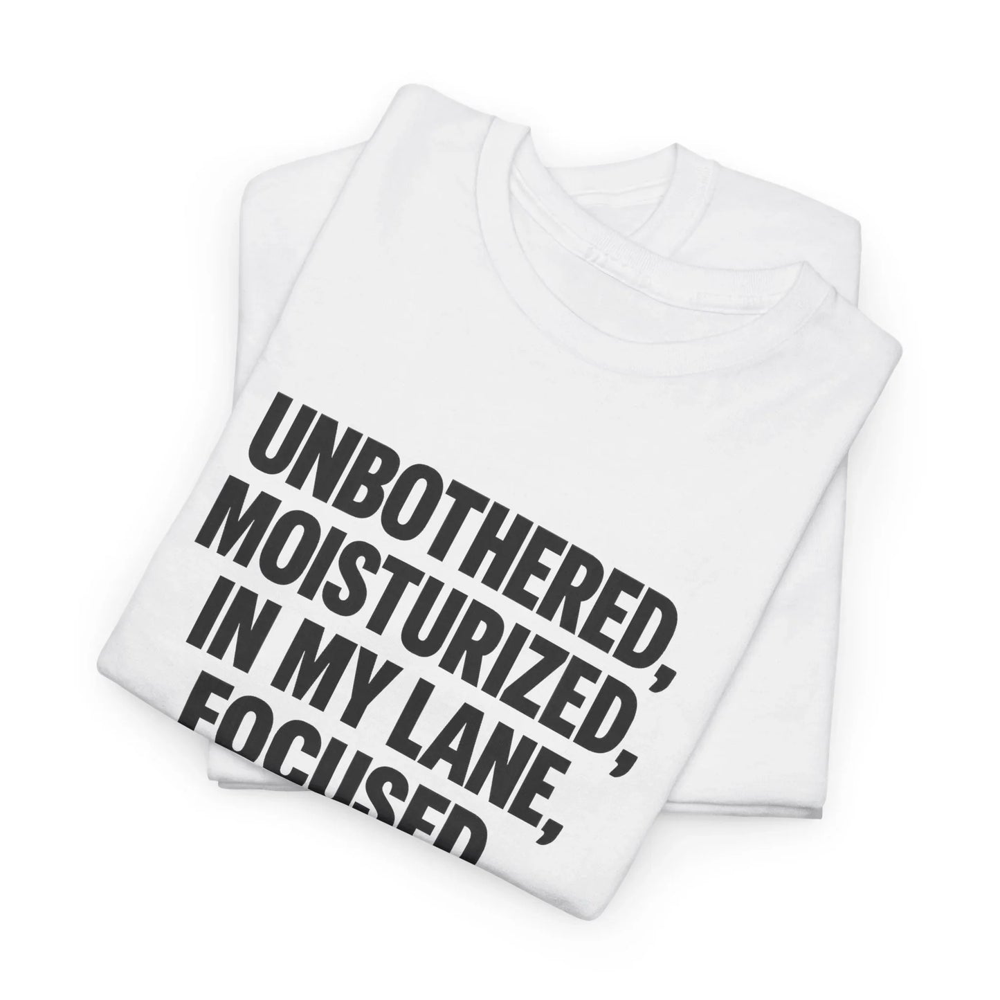 Folded white graphic t-shirt with bold black quote text: Unbothered, Moisturized, In My Lane, Focused.