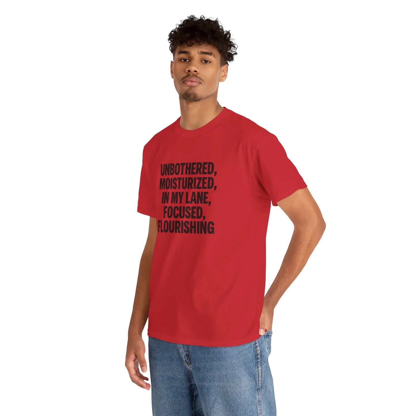 Man in red graphic tee with motivational text, casual jeans, white background