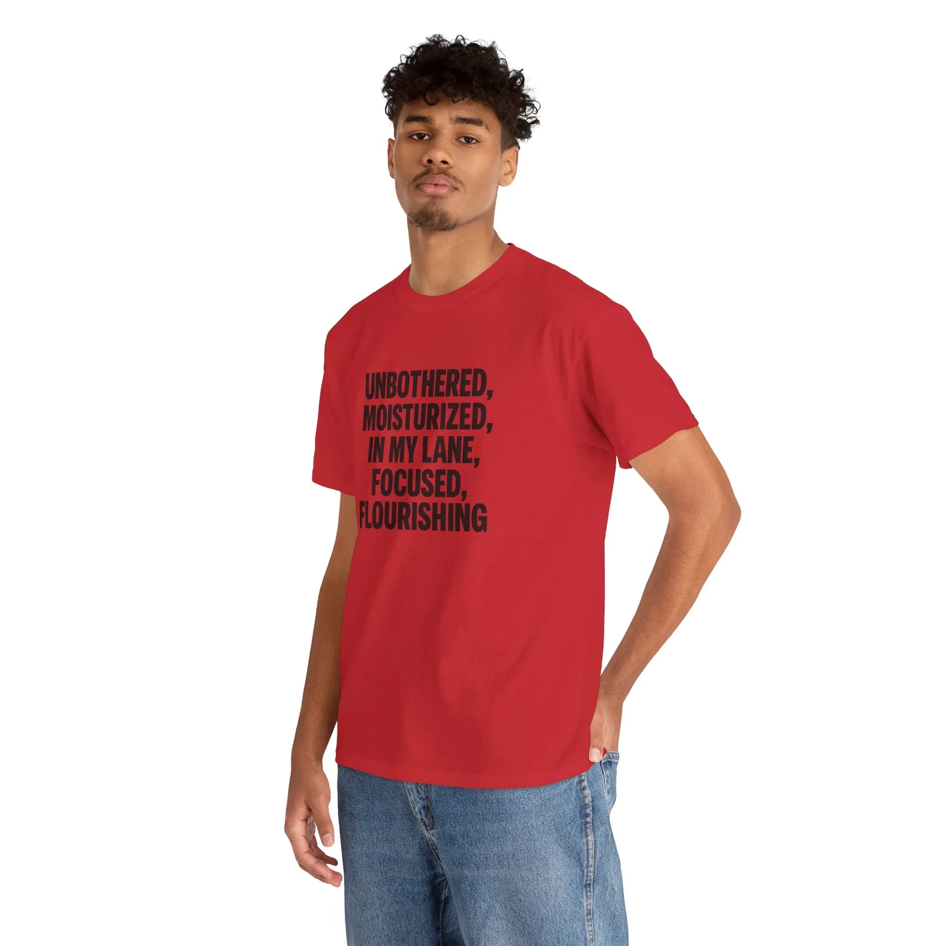 Man in red graphic tee with motivational text, casual jeans, white background