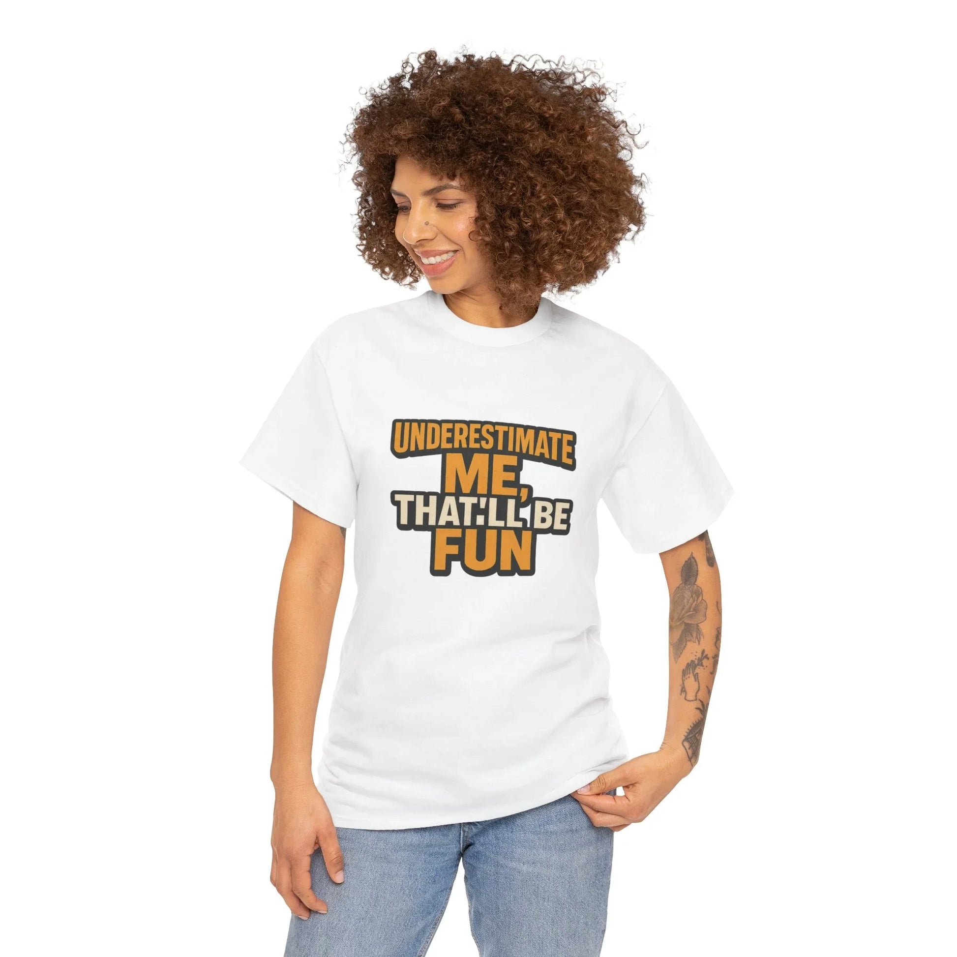 Woman wearing white graphic tee with 'Underestimate Me, That'll Be Fun' slogan, casual style