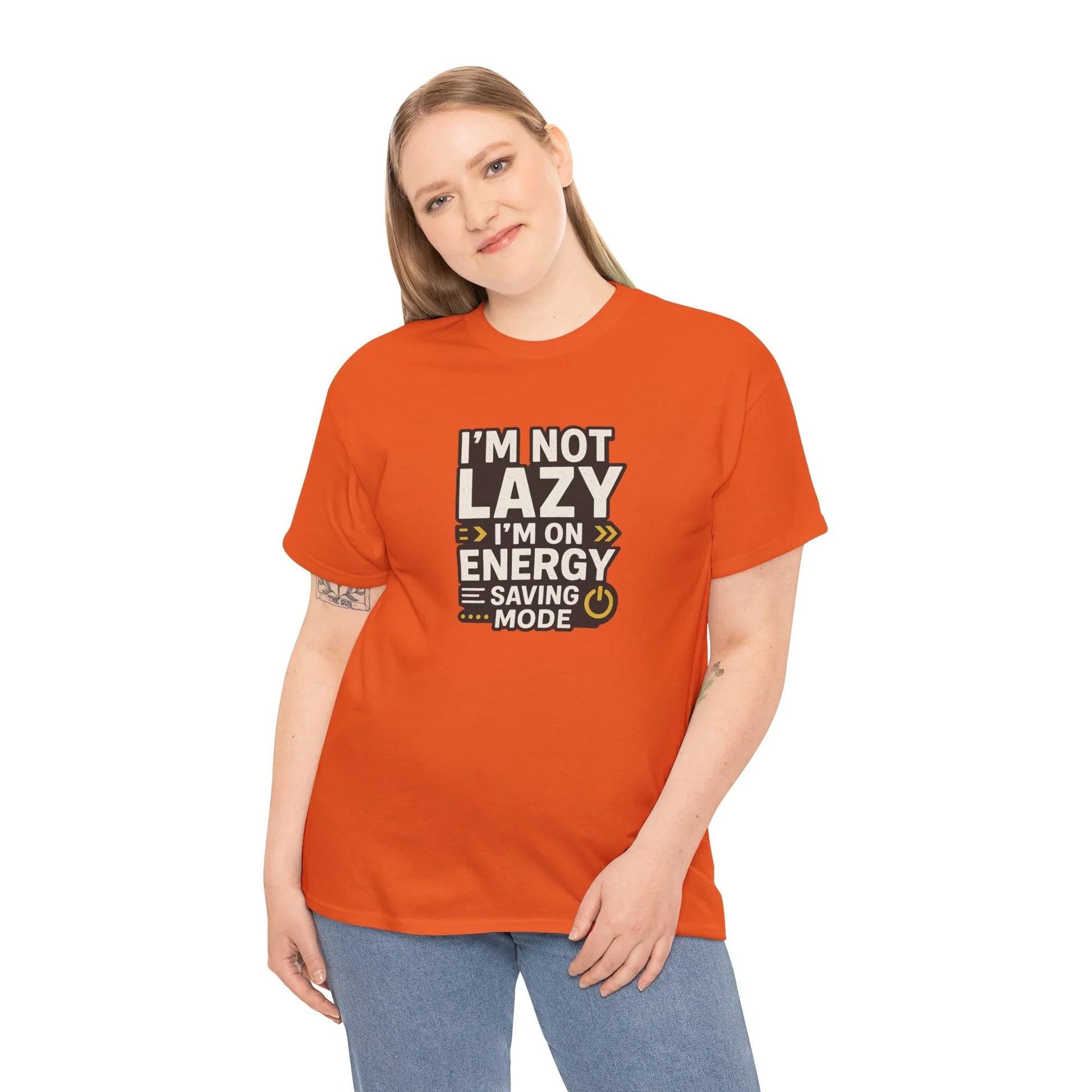 Woman wearing orange graphic tee with 'I'm not lazy, I'm on energy saving mode' quote
