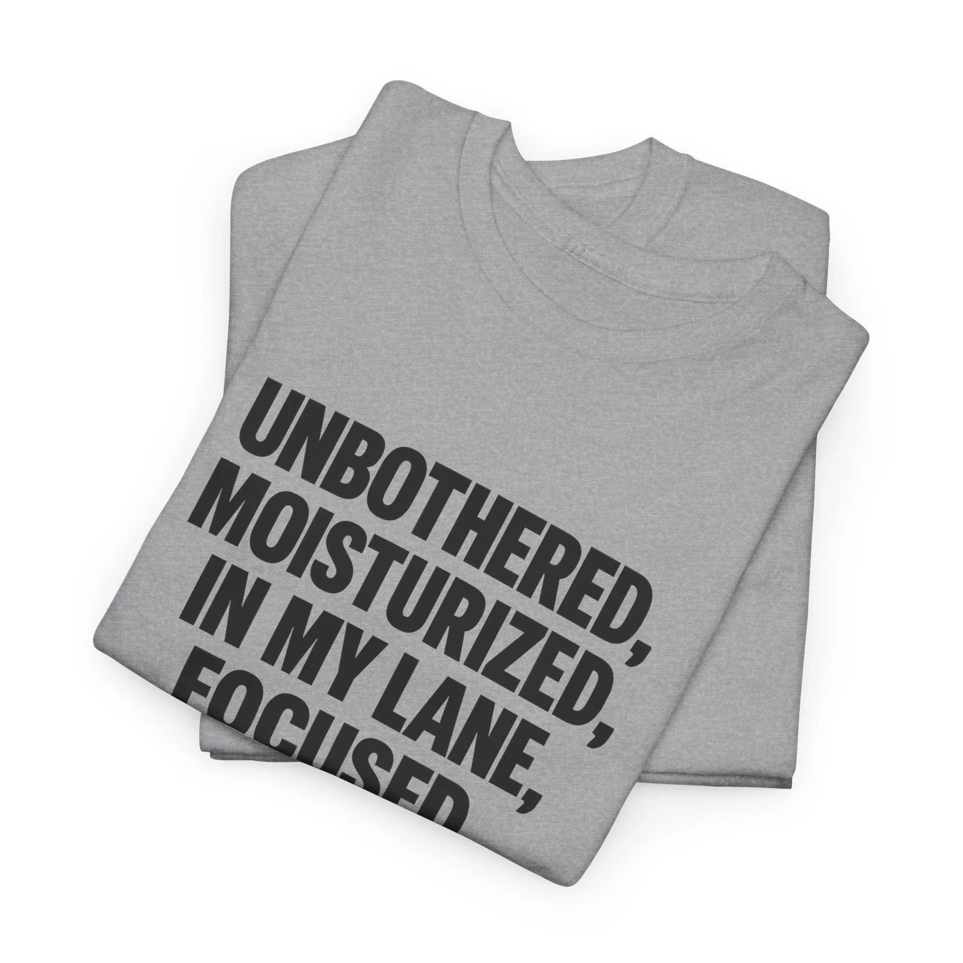 Folded gray t-shirt with bold black text 'Unbothered, Moisturized, In My Lane, Focused'